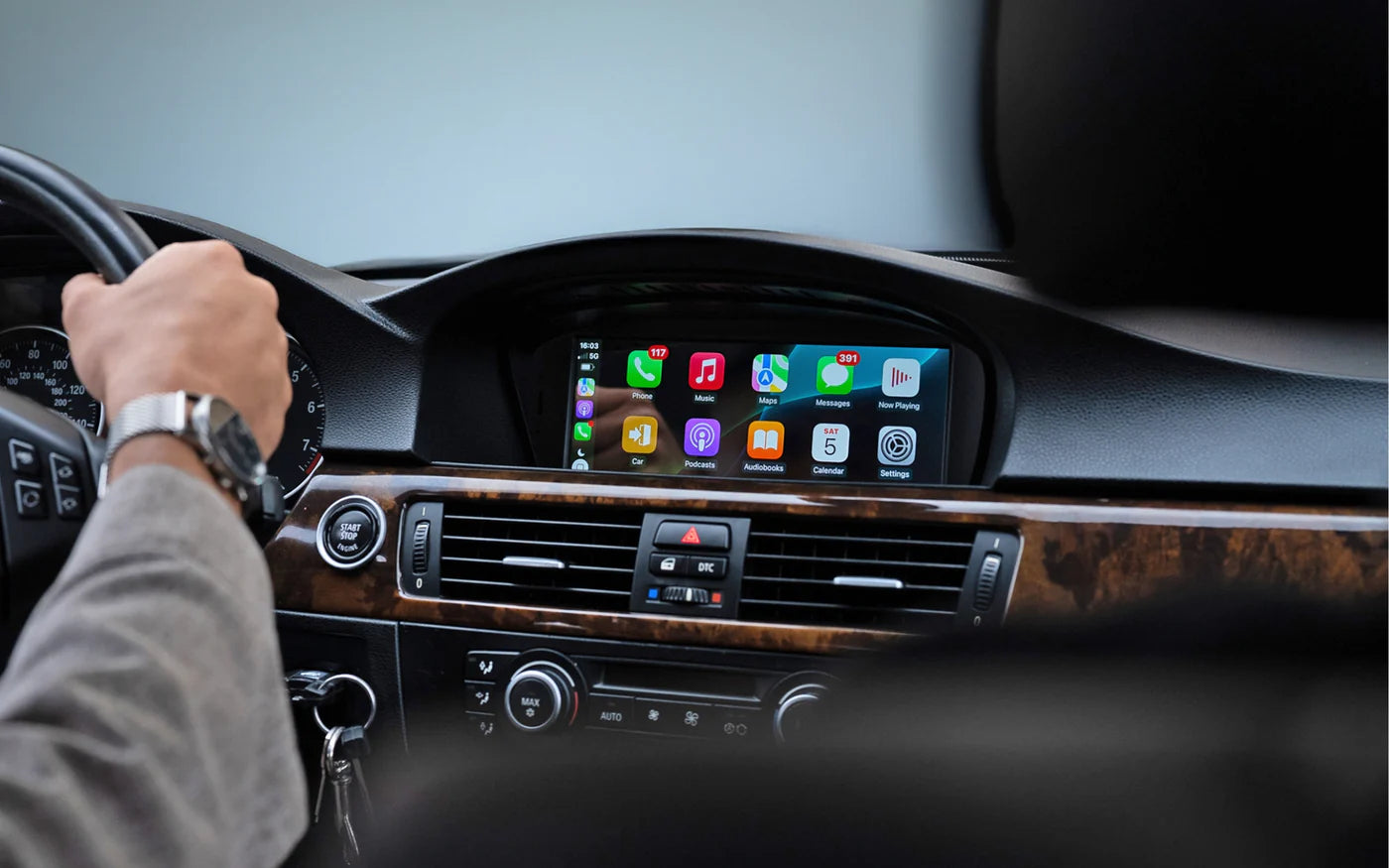 BMW 3 Series E90 E91 E92 E93 dashboard with Apple CarPlay and Android Auto displayed on original factory screen