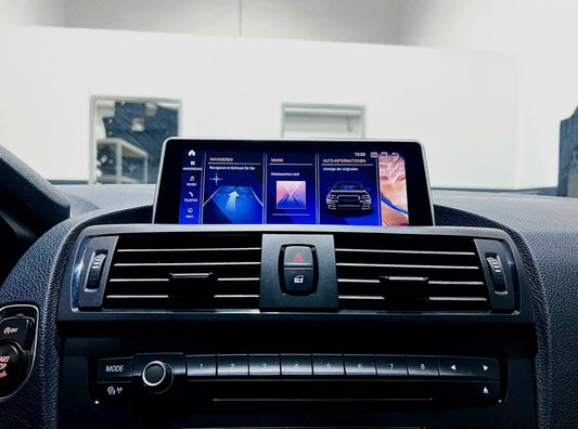 BMW infotainment screen upgrade with OEM-style interface showing navigation, music and vehicle information