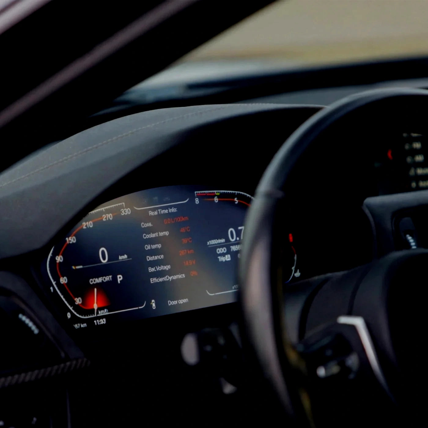 BMW digital instrument cluster showing real-time driving data, temperatures, efficiency and performance metrics