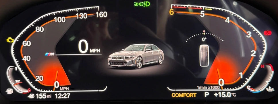 A close-up of a bmw digital instrument cluster display showing a speedometer, tachometer, fuel gauge, and a silver sedan graphic in the center.