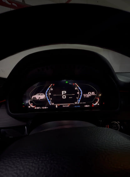 BMW digital instrument cluster shown from the driver view with vehicle visualization, speed, RPM and live driving data
