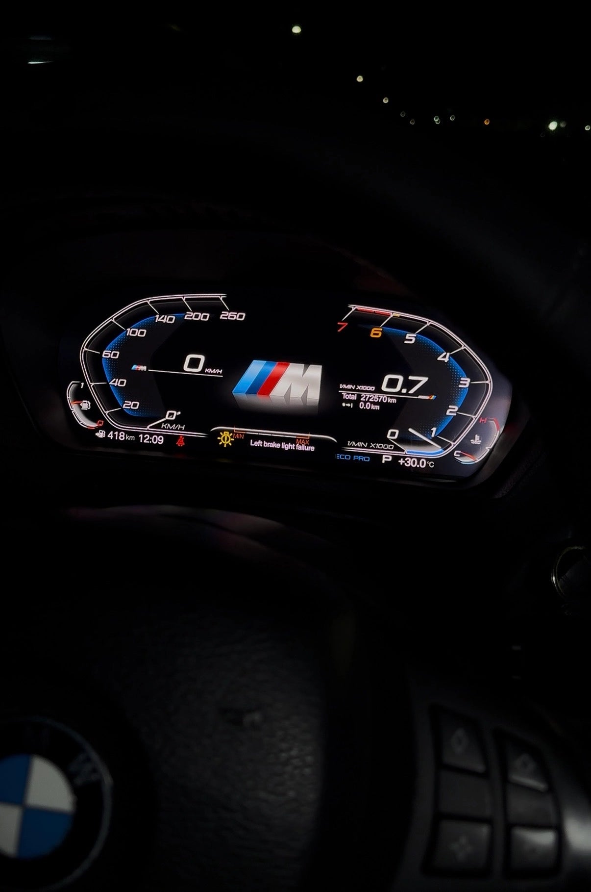 BMW digital instrument cluster installed at night with M-style display, warning message and illuminated driving data
