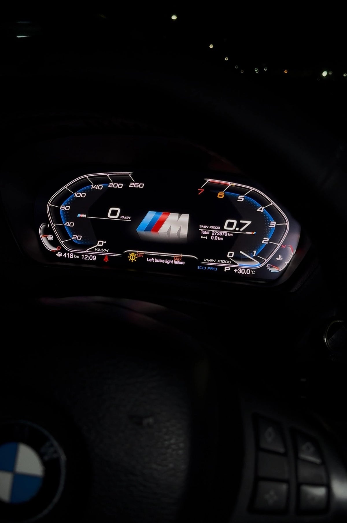 BMW digital instrument cluster installed at night with M-style display, warning message and illuminated driving data