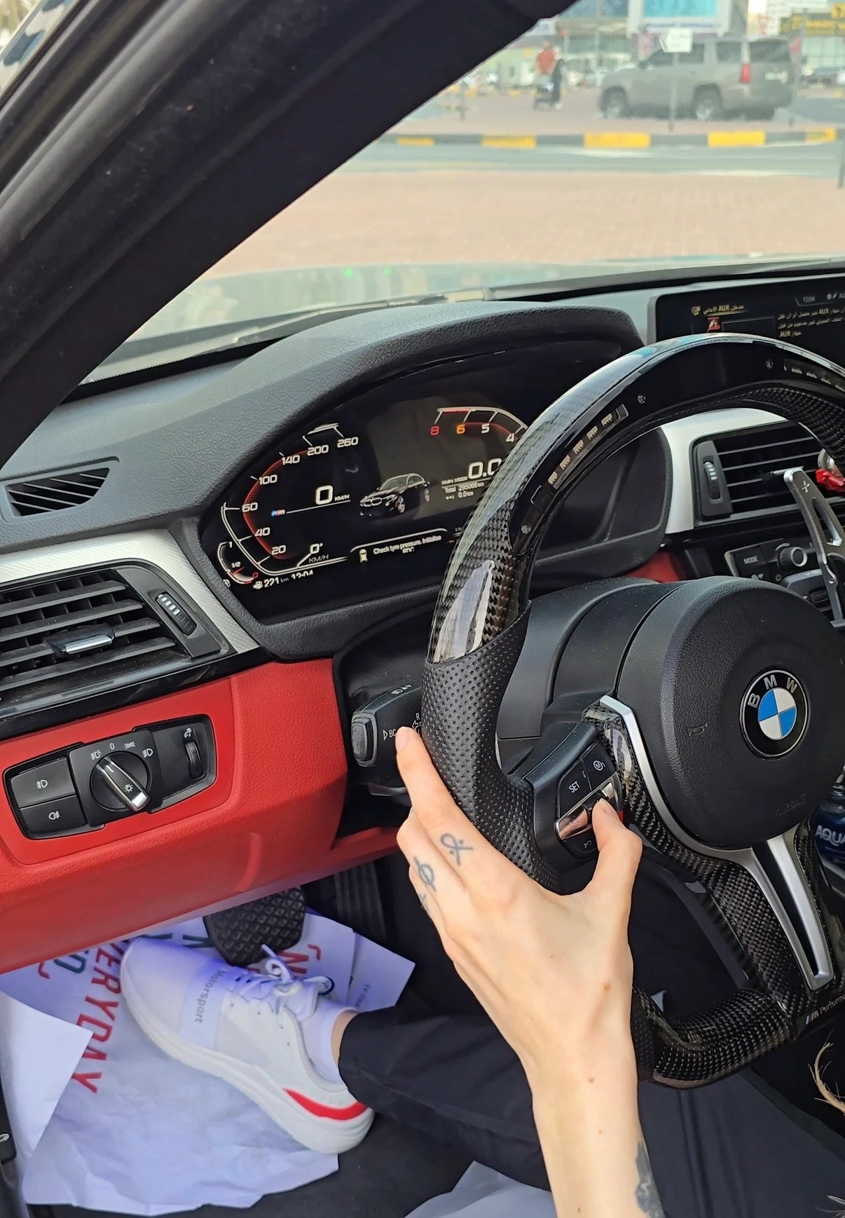 BMW digital instrument cluster integrated with the steering wheel controls and displayed in the driver cockpit