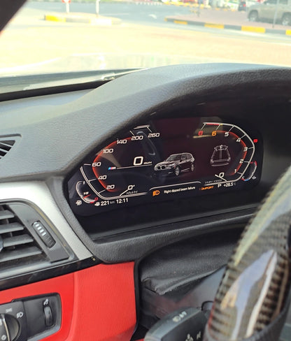 BMW digital instrument cluster showing vehicle visualization, warning message, speed, RPM and live driving data