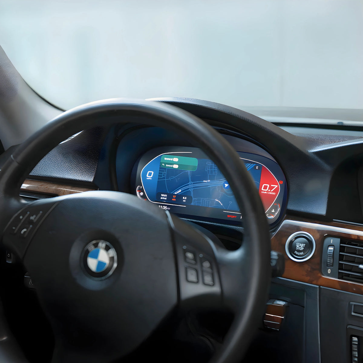 Close-up of a BMW digital cluster retrofit showing the carplay maps