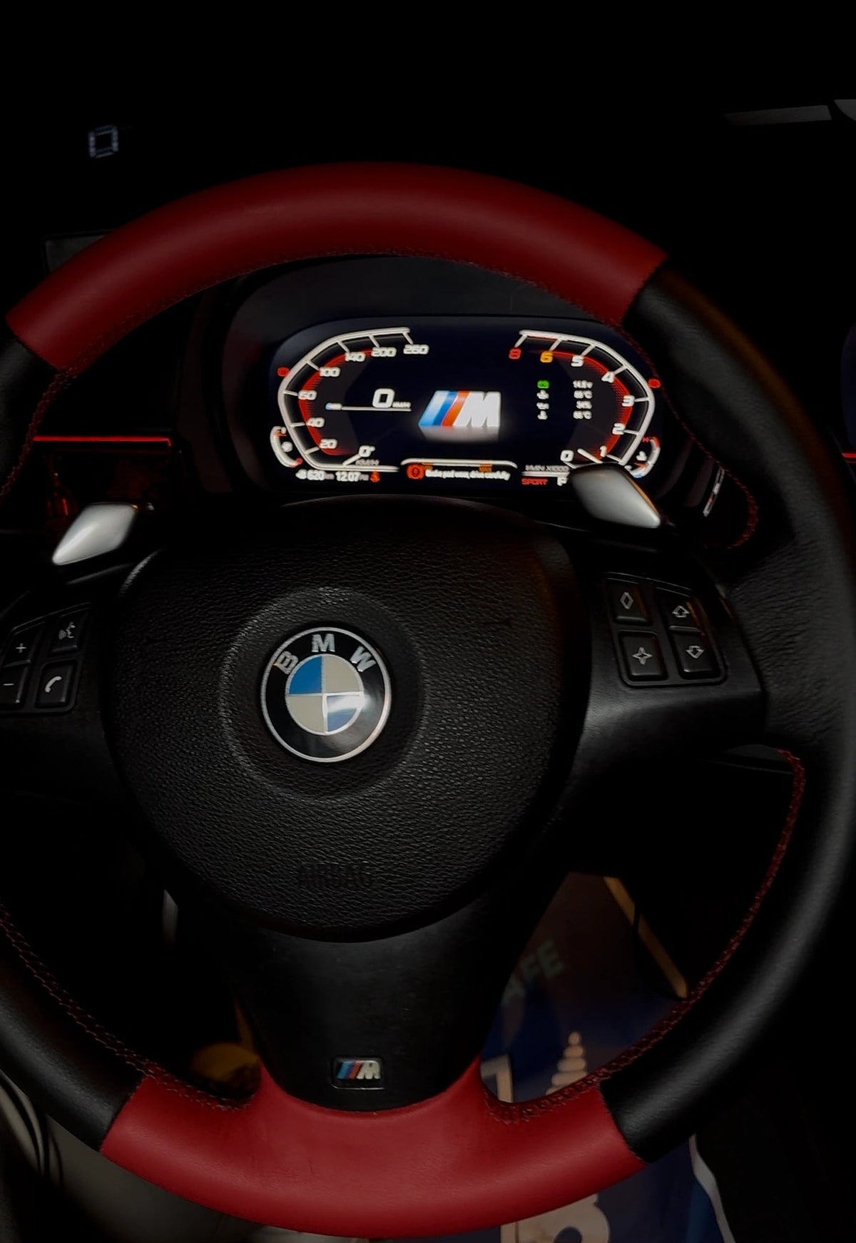 BMW E90 with upgraded digital cockpit display installed behind the steering wheel after retrofit