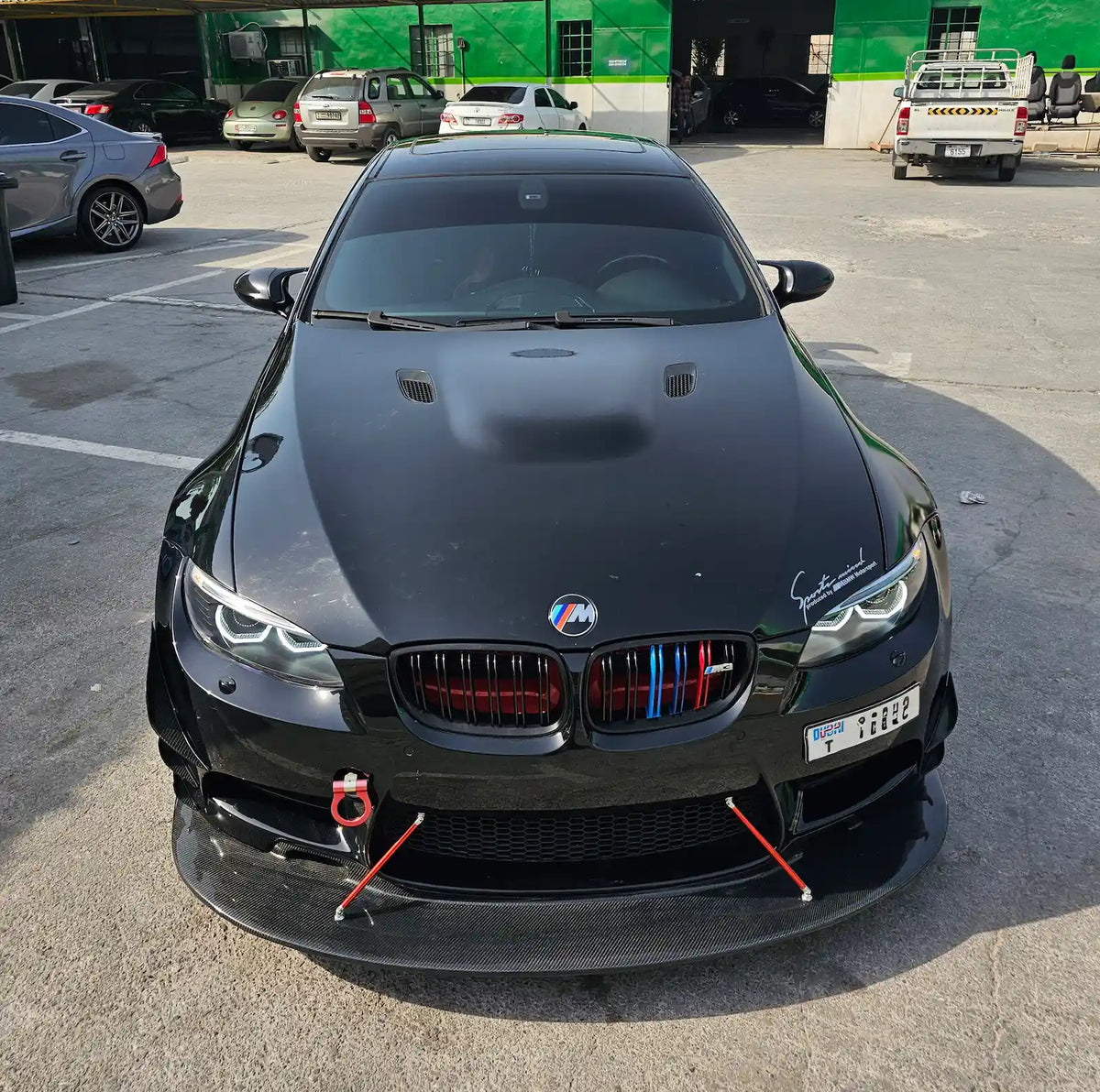 BMW E92 fitted with animated LED headlights, shown illuminated with white halo lighting from the front.