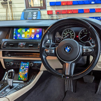 BMW F10 and F01 interior after installation of a 10.25-inch OEM-style Android touchscreen with Apple CarPlay