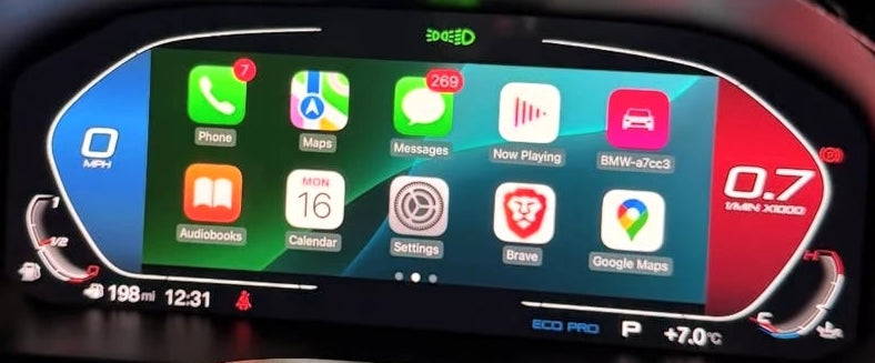 A close-up of a BMW's digital instrument cluster display showing Apple CarPlay interface icons, mounted on a steering wheel inside a vehicle.