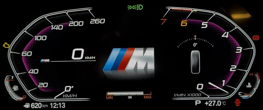 A close-up of a bmw's illuminated digital instrument cluster display on a black background, showing speedometer, tachometer, center speed readout, and the BMW M logo with the BMW flag colors.