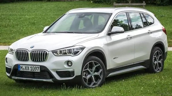 White BMW SUV X1 F48 parked on grass