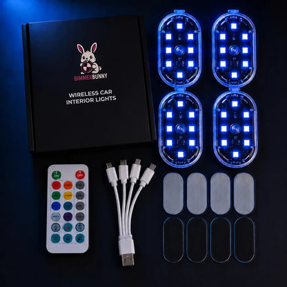 Wireless car interior lights kit by Bimmer Bunny, including four oval LED light modules glowing blue, a black remote control, a USB charging cable, five clear adhesive pads, and the product box on a dark background.
