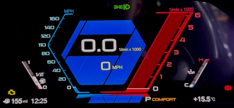 A close-up of a BMW's digital instrument cluster display showing a blue and red dashboard interface with speed, RPM, and temperature readings.